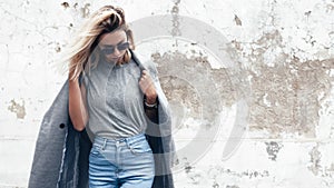 Model posing in plain tshirt against street wall