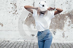 Model posing in plain tshirt against street wall photo