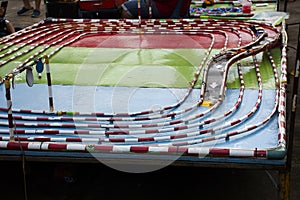 Model racetrack racecourse or racing circuit motorsports and toy car running in pit lane for thai children and kid playing photo