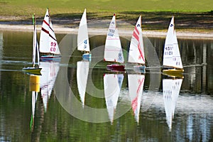 Model radio controlled sailboat regatta race on lake