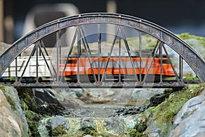 Model railroad. Portuguese locomotive on a bridge.