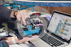 Model of a robot in the hands of a teacher during a robotics lesson