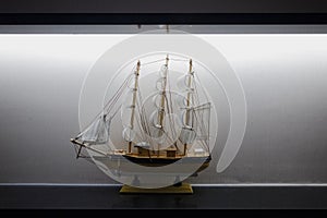 Model Sailboat Frigate Sitting on Display Shelf Lights Black White Elegant Decoration Centered