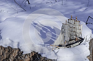 Model of a sailboat on a winter scene. silhouette of a shadow