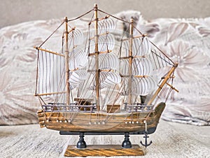 Model of a sailing ship on a beige background