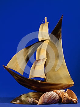 A model of a sailing ship on a blue background.