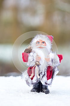 Model of Santa Claus standing in white snow outdoors