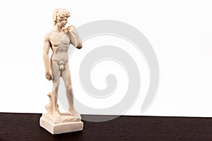 Model statue of David on wooden table,