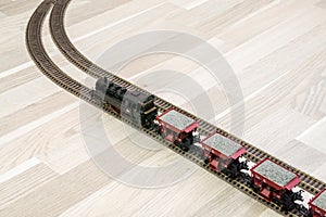 Model steam train on wooden floor, game for adults