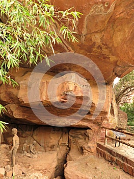 A model of Stone Age family as well as actual petroglyphs on cave ceiling, Bhimbetka rock shelter, Madhya Pradesh, India