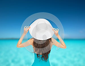 Model in swimsuit with hat