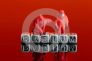 Model team in chemical suits with the word radium on beads