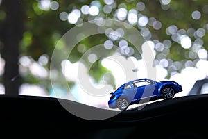 Model toy car with bokeh green natural background