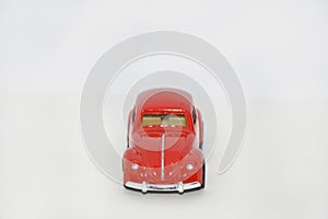 model of a toy car in red color on a white background