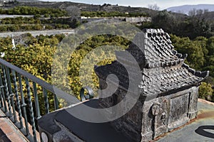 Model of a traditional oriental house on a fence decorating a viewpoint in MelegÃÂ­ Granada with lemon trees in the background photo