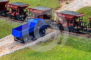 Model train cars loaded by coal with heavy truck, model scale H0