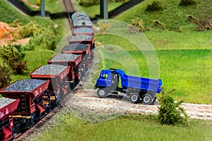 Model train cars loaded by coal with heavy truck, model scale H0