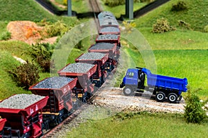 Model train cars loaded by coal with heavy truck, model scale H0