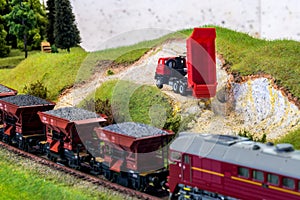 Model train cars loaded by coal with heavy truck, model scale H0