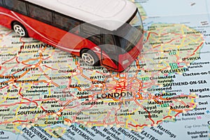 Model of travel bus on the map of London. Travelling by bus concept. Conceptual image for travel and tourism