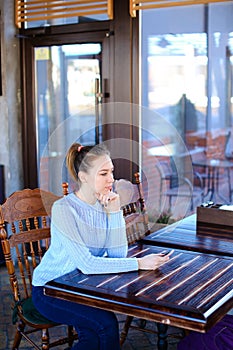 Model waiting photographer for photoshoot in cafe