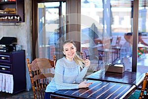 Model waiting photographer for photoshoot in cafe