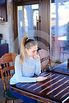 Model waiting photographer for photoshoot in cafe