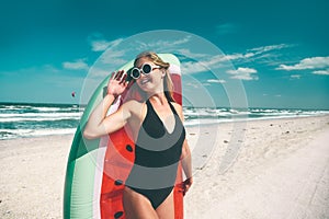 Model with watermelon lilo at the beach