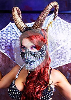 Model wearing Halloween costume of leather and horns