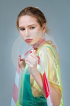 Model wearing plastic coat posing with strip on neck photo