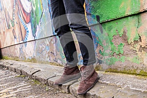 Model wearing skinny trousers and brown boots