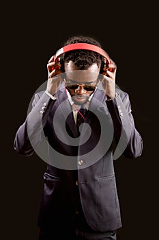 Model wearning red headphones on head and concentrated on song