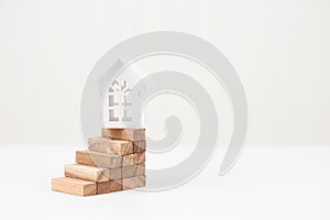 Model white house on wood block stacking step stair. Property investment and house mortgage financial concept, Home protect,