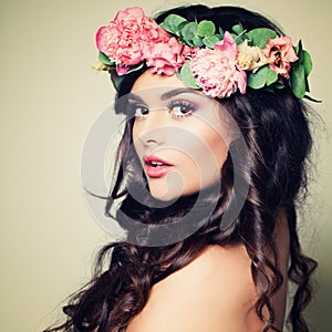 Model Woman with Makeup, Long Curly Hair and Flowers. Su