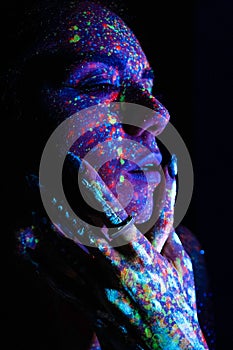 Model woman in neon light, beautiful model girl with fluorescent makeup, art design of disco dancer dancing in uv light