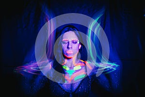 Model woman in neon light, beautiful model girl with fluorescent makeup, art design of disco dancer dancing in uv light