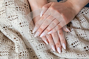 Model woman showing .light pale pink nude shellac manicure on lo