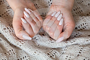 Model woman showing .light pale pink nude shellac manicure on lo