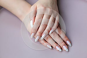 Model woman showing .light white nude shellac manicure on long n photo