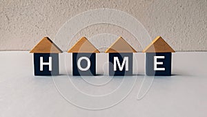 Model wooden house with text - HOME. Home concept