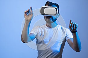 Model young man with beard in glasses of virtual reality. Augmented reality, science, future technology, VR. Futuristic