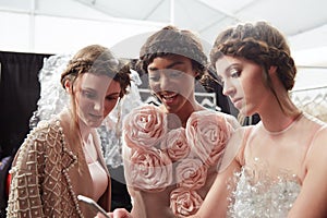 Models getting ready backstage at the New York Life fashion show during MBFW Fall 2015