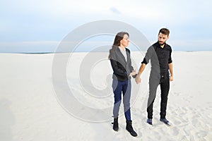 models man and woman jumping for joy at seaside.