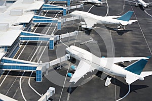 Models of modern aircraft standing at miniature airport.