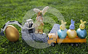 models of a toy excavator and a yellow dump truck with bright colorful Easter eggs