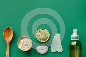 Moden cosmetic ingredients on a green background. Aloe vera gel and masks photo