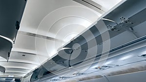 Moder airplane ceiling and open luggage compartment