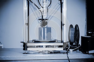 Modern 3D printer printing figure close-up. Copy space.