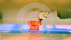 Modern 3D printer printing an object from the hot molten.