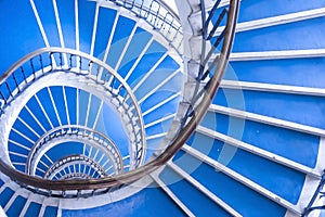 Modern abstract spiral staircase, bauhaus style, blue and white staircase photo